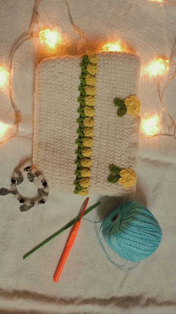 White crochet clutch with yellow rose lace border in between and yellow flower.