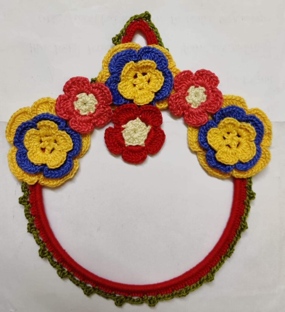Hand-weaved crochet wall hanging cum napkin holder with beautiful yellow red and pink flowers